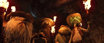 Movie still from “Rango” (2011), directed by Gore Verbinski – A group of people standing next to each other holding torches; Medium shot, Low angle