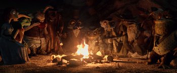 Movie still from “Rango” (2011), directed by Gore Verbinski – A group of people that are around a fire pit; Wide shot, High angle