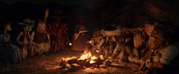 Movie still from “Rango” (2011), directed by Gore Verbinski – A group of people sitting around a fire; Wide shot, High angle