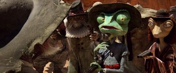 Movie still from “Rango” (2011), directed by Gore Verbinski – A group of people dressed up like characters from the wizard of oz; Close Up shot, Over the shoulder angle