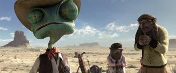 Movie still from “Rango” (2011), directed by Gore Verbinski – A couple of people standing next to each other in the desert; Close Up shot, Low angle