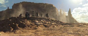 Movie still from “Rango” (2011), directed by Gore Verbinski – A group of people standing on top of a dirt hill; Extreme Wide shot, Low angle