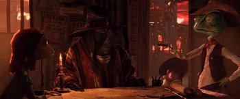 Movie still from “Rango” (2011), directed by Gore Verbinski – An image of a man sitting at a table with a hat on; Medium shot, Low angle