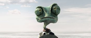 Movie still from “Rango” (2011), directed by Gore Verbinski – A green lizard head is on top of a man's arm; Extreme Close Up shot, Low angle