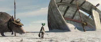 Movie still from “Rango” (2011), directed by Gore Verbinski – A man with a bag on his head standing in front of a boat; Extreme Wide shot, Low angle