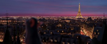 Movie still from “Ratatouille” (2007), directed by Jan Pinkava – An image of a person standing in front of a city at night; Extreme Wide shot, High angle