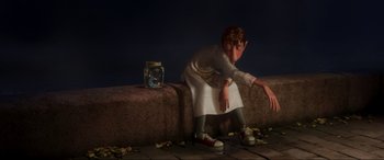 Movie still from “Ratatouille” (2007), directed by Jan Pinkava – A person sitting on a ledge next to a jar of goldfish; Wide shot, Low angle