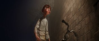 Movie still from “Ratatouille” (2007), directed by Jan Pinkava – An animated character is standing next to a microphone; Medium shot, Low angle