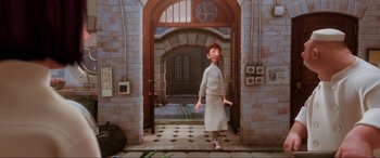 Movie still from “Ratatouille” (2007), directed by Jan Pinkava – An animated picture of a person walking in a room; Wide shot, High angle