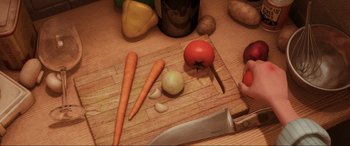 Movie still from “Ratatouille” (2007), directed by Jan Pinkava – A cutting board topped with carrots , onions , tomatoes , and a knife; Extreme Close Up shot, Overhead angle