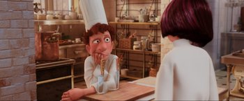Movie still from “Ratatouille” (2007), directed by Jan Pinkava – An animated character sitting at a table in a kitchen; Close Up shot, Over the shoulder angle