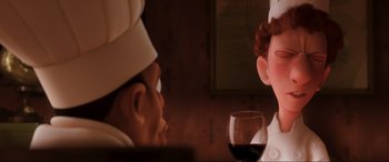 Movie still from “Ratatouille” (2007), directed by Jan Pinkava – A person with a chef hat on and a glass of red wine in front of them; Close Up shot, Over the shoulder angle