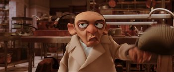 Movie still from “Ratatouille” (2007), directed by Jan Pinkava – An animated man with a bald head wearing a trench coat; Close Up shot, High angle