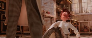 Movie still from “Ratatouille” (2007), directed by Jan Pinkava – A woman sitting on a chair in a room; Medium shot, Over the shoulder angle