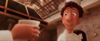 Movie still from “Ratatouille” (2007), directed by Jan Pinkava – An image of an animated character holding a coffee cup; Close Up shot, Over the shoulder angle