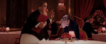 Movie still from “Ratatouille” (2007), directed by Jan Pinkava – A man and a woman sitting at a dinner table; Medium shot, Over the shoulder angle