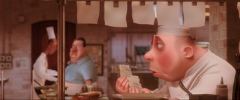 Movie still from “Ratatouille” (2007), directed by Jan Pinkava – An animated character eating a piece of paper; Medium shot, Low angle