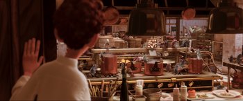 Movie still from “Ratatouille” (2007), directed by Jan Pinkava – A person is standing in front of a counter; Wide shot, High angle