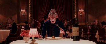 Movie still from “Ratatouille” (2007), directed by Jan Pinkava – An animated man sitting at a table with a knife and fork in front of him; Medium shot, Over the shoulder angle