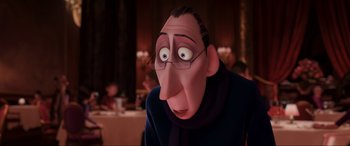 Movie still from “Ratatouille” (2007), directed by Jan Pinkava – An animated man with glasses wearing a blue sweater; Close Up shot, Over the shoulder angle
