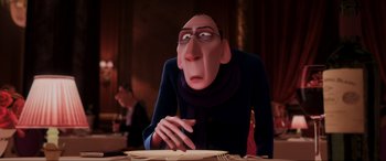 Movie still from “Ratatouille” (2007), directed by Jan Pinkava – An animated man with glasses sitting at a dinner table; Close Up shot, Over the shoulder angle