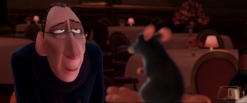 Movie still from “Ratatouille” (2007), directed by Jan Pinkava – An animated man and a mouse in a dark room; Close Up shot, Over the shoulder angle