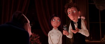 Movie still from “Ratatouille” (2007), directed by Jan Pinkava – A woman and a man standing next to each other holding a mouse; Medium shot, Over the shoulder angle