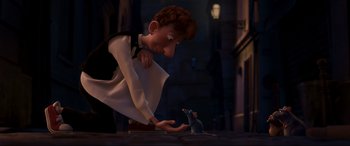 Movie still from “Ratatouille” (2007), directed by Jan Pinkava – A man and a mouse in the movie ratatouille; Medium shot, Over the shoulder angle