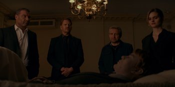 Movie still from “Ray Donovan: The Movie” (2022), directed by David Hollander – A couple of men standing next to each other in a room; Medium shot, Over the shoulder angle
