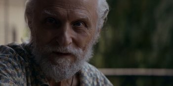 Movie still from “Ray Donovan: The Movie” (2022), directed by David Hollander – An old man with a beard and a white beard; Close Up shot, Over the shoulder angle