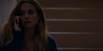 Movie still from “Ray Donovan: The Movie” (2022), directed by David Hollander – A person with long blonde hair; Close Up shot, Over the shoulder angle