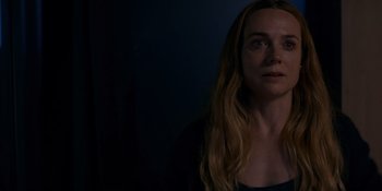 Movie still from “Ray Donovan: The Movie” (2022), directed by David Hollander – A woman with long blonde hair looking into the distance; Close Up shot, Over the shoulder angle