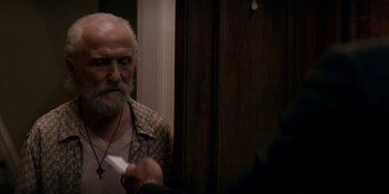 Movie still from “Ray Donovan: The Movie” (2022), directed by David Hollander – An old man with a beard and a mustache is looking at himself in the mirror; Close Up shot, Over the shoulder angle