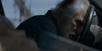 Movie still from “Ray Donovan: The Movie” (2022), directed by David Hollander – An old man with a beard is leaning against a wall; Close Up shot, Low angle