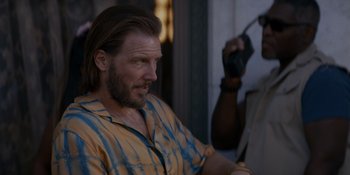 Movie still from “Ray Donovan: The Movie” (2022), directed by David Hollander – A person with a beard; Close Up shot, Over the shoulder angle