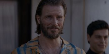 Movie still from “Ray Donovan: The Movie” (2022), directed by David Hollander – A person with a beard; Close Up shot, Over the shoulder angle