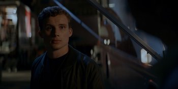 Movie still from “Ray Donovan: The Movie” (2022), directed by David Hollander – A man in a black jacket is looking at the camera; Close Up shot, Low angle