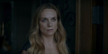 Movie still from “Ray Donovan: The Movie” (2022), directed by David Hollander – A woman with long blonde hair looking at the camera; Close Up shot, Over the shoulder angle