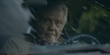 Movie still from “Ray Donovan: The Movie” (2022), directed by David Hollander – An older man looking out of a car window; Close Up shot, Low angle