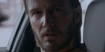 Movie still from “Ray Donovan: The Movie” (2022), directed by David Hollander – A person with a beard; Close Up shot, Over the shoulder angle