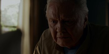 Movie still from “Ray Donovan: The Movie” (2022), directed by David Hollander – An old man with a white beard looking at the camera; Close Up shot, Over the shoulder angle