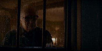 Movie still from “Ray Donovan: The Movie” (2022), directed by David Hollander – An older man looking out of a window at night; Close Up shot, Low angle