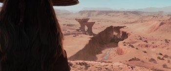 Movie still from “Raya and the Last Dragon” (2021), directed by Don Hall – A woman looking out over a desert landscape; Extreme Wide shot, High angle