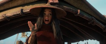 Movie still from “Raya and the Last Dragon” (2021), directed by Don Hall – A girl with long gray hair wearing a straw hat; Close Up shot, Over the shoulder angle