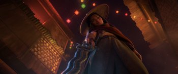 Movie still from “Raya and the Last Dragon” (2021), directed by Don Hall – A woman wearing a hat is holding a cell phone; Wide shot, Low angle