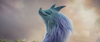 Movie still from “Raya and the Last Dragon” (2021), directed by Don Hall – A blue furry creature with a big smile on its face; Close Up shot, Low angle