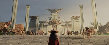 Movie still from “Raya and the Last Dragon” (2021), directed by Don Hall – A woman wearing a hat standing in front of a building; Extreme Wide shot, Low angle