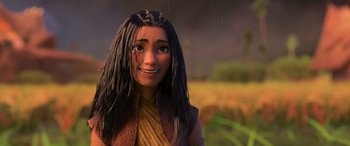 Movie still from “Raya and the Last Dragon” (2021), directed by Don Hall – A woman with long black hair is smiling for the camera; Close Up shot, Over the shoulder angle
