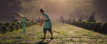 Movie still from “Raya and the Last Dragon” (2021), directed by Don Hall – A woman is holding a wooden stick in the middle of a path; Wide shot, Over the shoulder angle