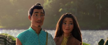 Movie still from “Raya and the Last Dragon” (2021), directed by Don Hall – A man and a woman standing next to each other in front of trees; Close Up shot, Over the shoulder angle